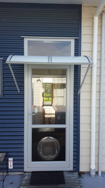Hardtop light-filtering fibreglass awning over the back door