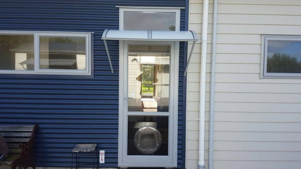 Hardtop light-filtering fibreglass awning over the back door