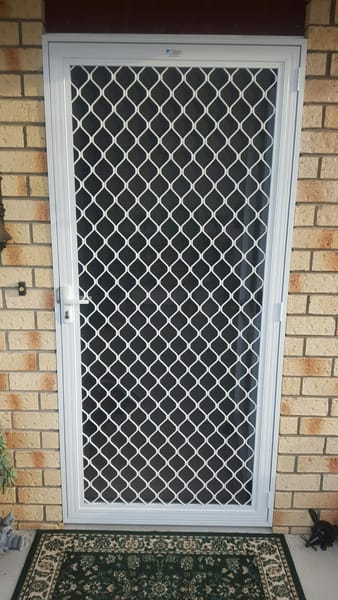 Hinged security screen door with build-out frame