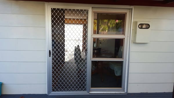 Sliding security screen door with build-out frame