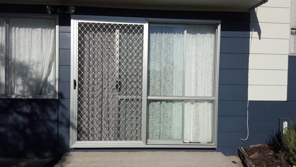 Sliding security screen door with build-out frame